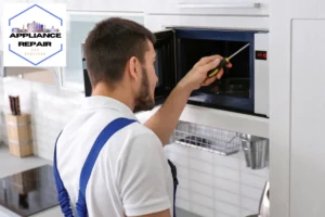 man repairing microwave oven in the kitchen
