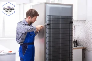 Serviceman In Overall Working On Fridge