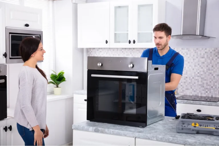 repairman repairing oven in the kitchen
