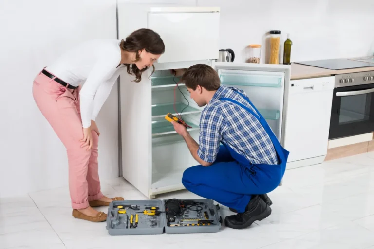 Worker repairing fridge