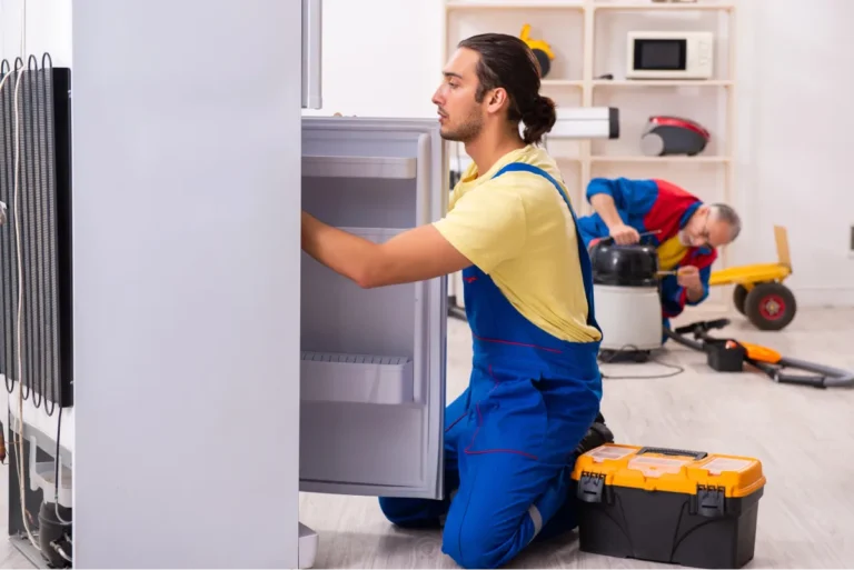 two contractors repairing fridge