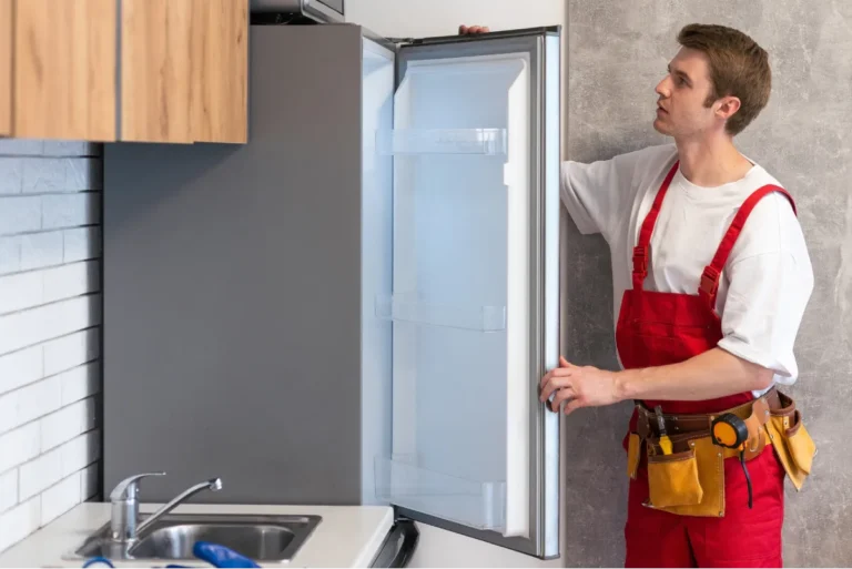 worker repairing fridge