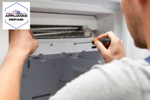 The repairer is fixing the freezer at home