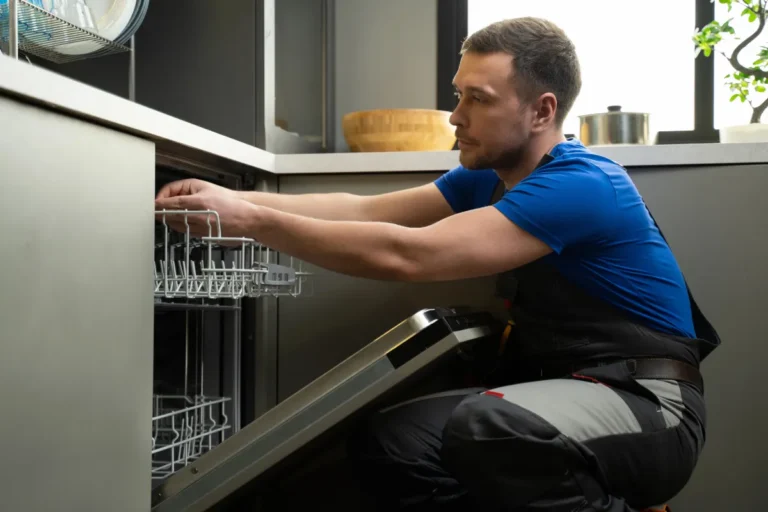 Repairman checking dishwasher