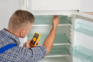 tech checking refrigerator