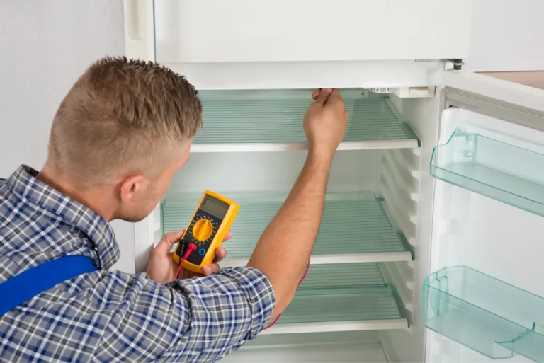 tech checking refrigerator