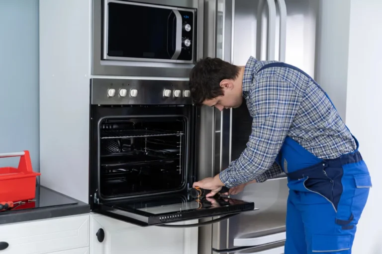 male technician installling oven in the kitchen